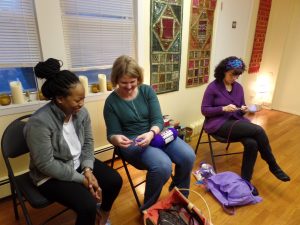 Kira helping new member Rebekah learn to crochet