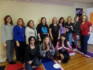 Jessica, Adria, and the participants with the mala beads they created