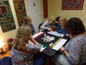 One of the Mah Jongg tables with Pat helping newer students