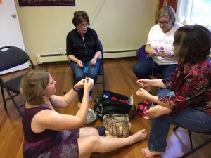 Kira showing newcomers how to crochet